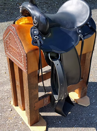 Brown trail saddle with standard border tooling and E-Z ride stirrups